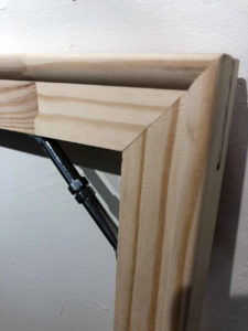 Detail of stretcher bar corner with expansion hardware.